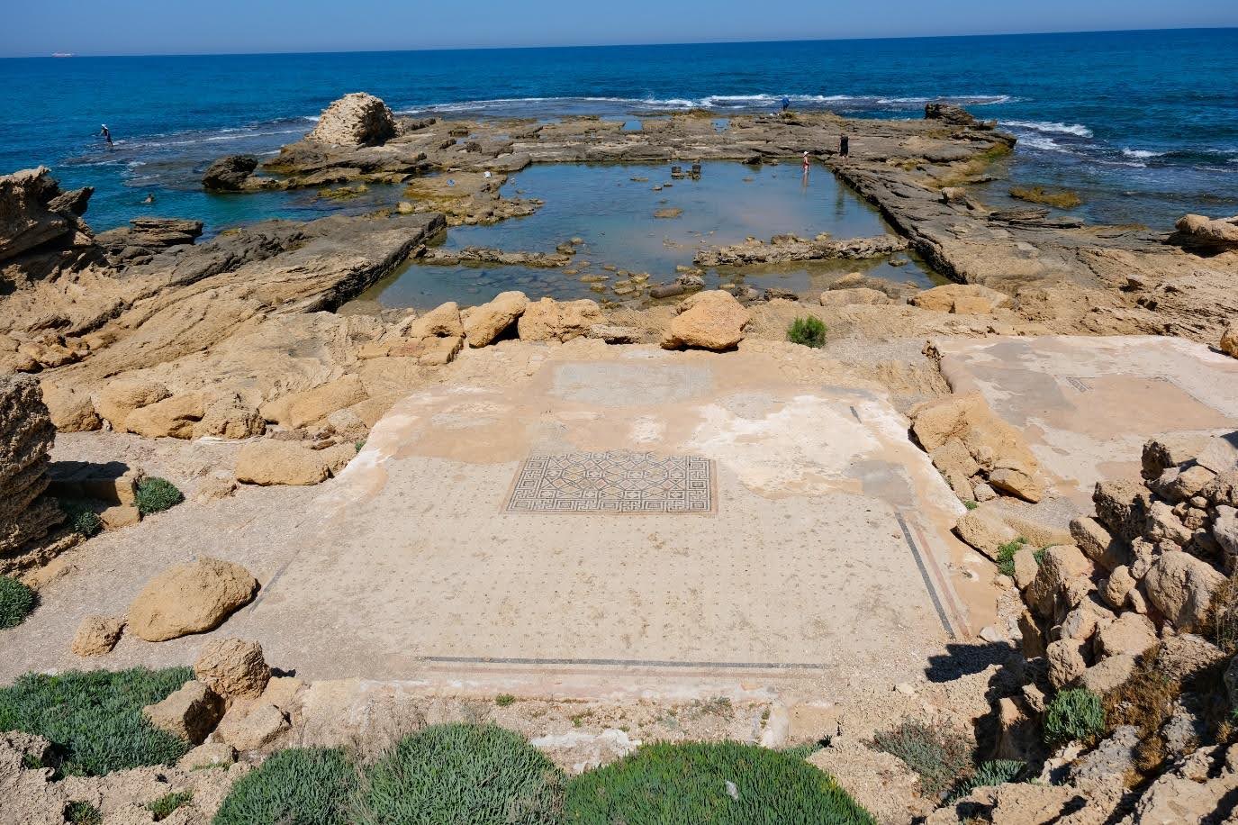 Remains of the mosaic floor of the triclinium (dining room) of Herod’s palace. Beyond it, Herod had a swimming pool fed with fresh water cut into the rock. To the left of the pool, a small private harbour would allow Herod to come to and go out of his palace incognito. Reed Miller, 2021. Remains of the mosaic floor of the triclinium (dining room) of Herod’s palace. Beyond it, Herod had a swimming pool fed with fresh water cut into the rock. To the left of the pool, a small private harbour would allow Herod to come to and go out of his palace incognito. Reed Miller, 2021.<br />