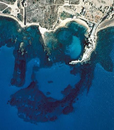 The breakwater built by Herod’s engineers has sunk into the sea. It can be seen in aerial photography: the dark stain in the deep blue of the sea. Source: R. L. Hohfelder et al. “Constructing the Harbour of Caesarea Palaestina, Israel: New Evidence From the ROMACONS Field Campaign of October 2005,” The International Journal of Nautical Archaeology (2007) 36.2: 409-415. The breakwater built by Herod’s engineers has sunk into the sea. It can be seen in aerial photography: the dark stain in the deep blue of the sea. Source: R. L. Hohfelder et al. “Constructing the Harbour of Caesarea Palaestina, Israel: New Evidence From the ROMACONS Field Campaign of October 2005,” The International Journal of Nautical Archaeology (2007) 36.2: 409-415.